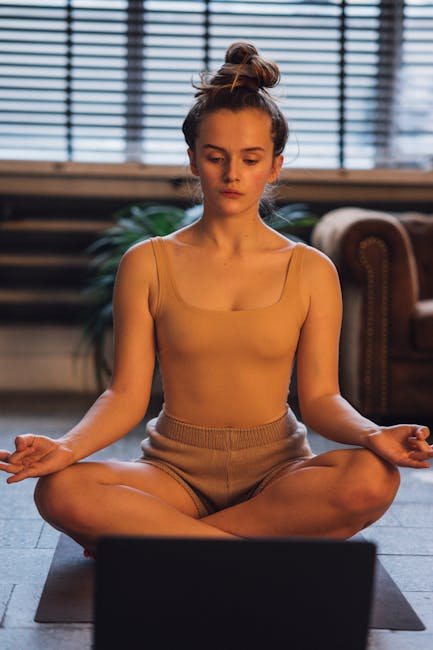 A person rolling out a yoga mat at home, ready to start a practice.